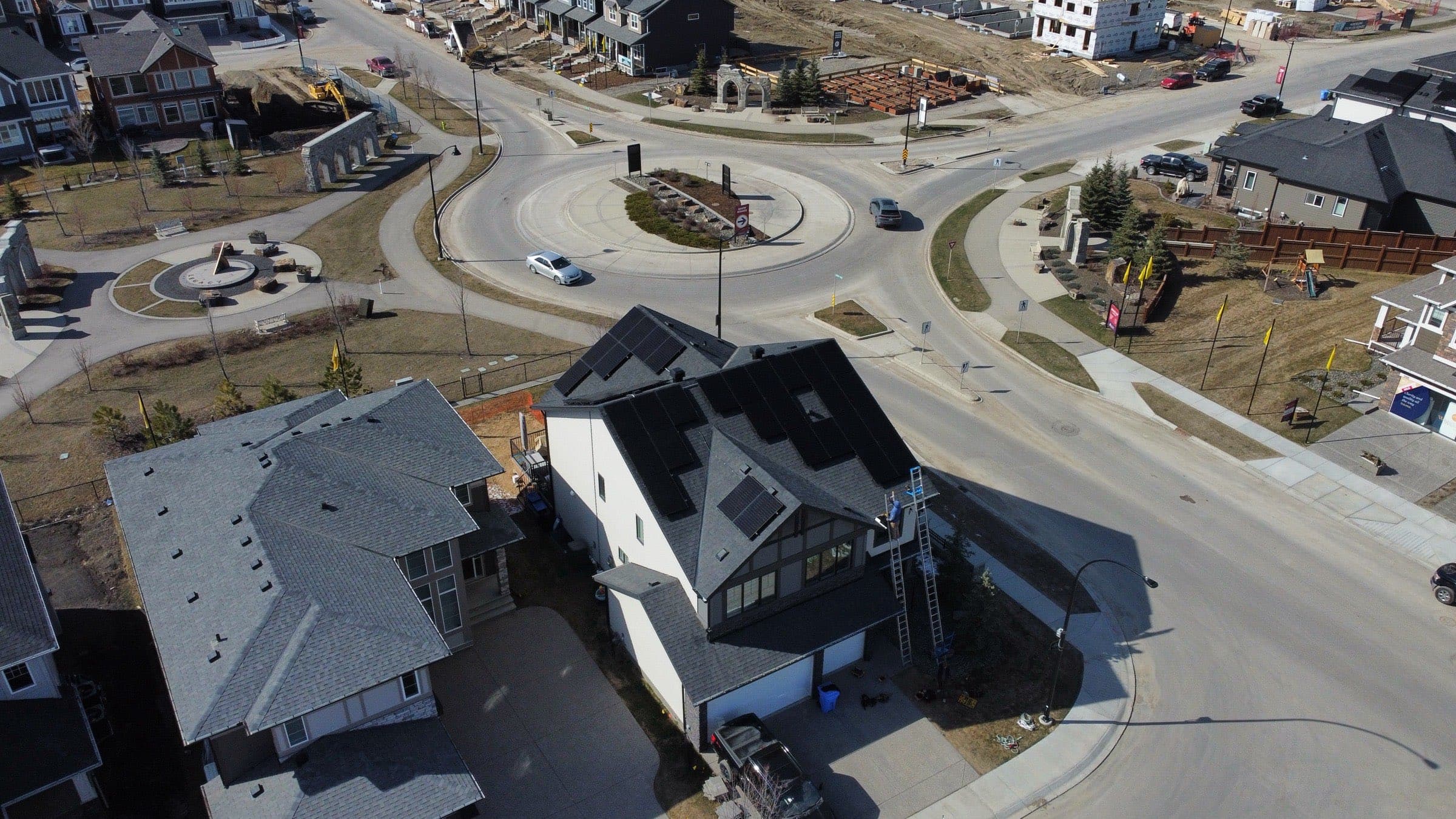 Rooftop solar arrays across a Chestermere street, from above