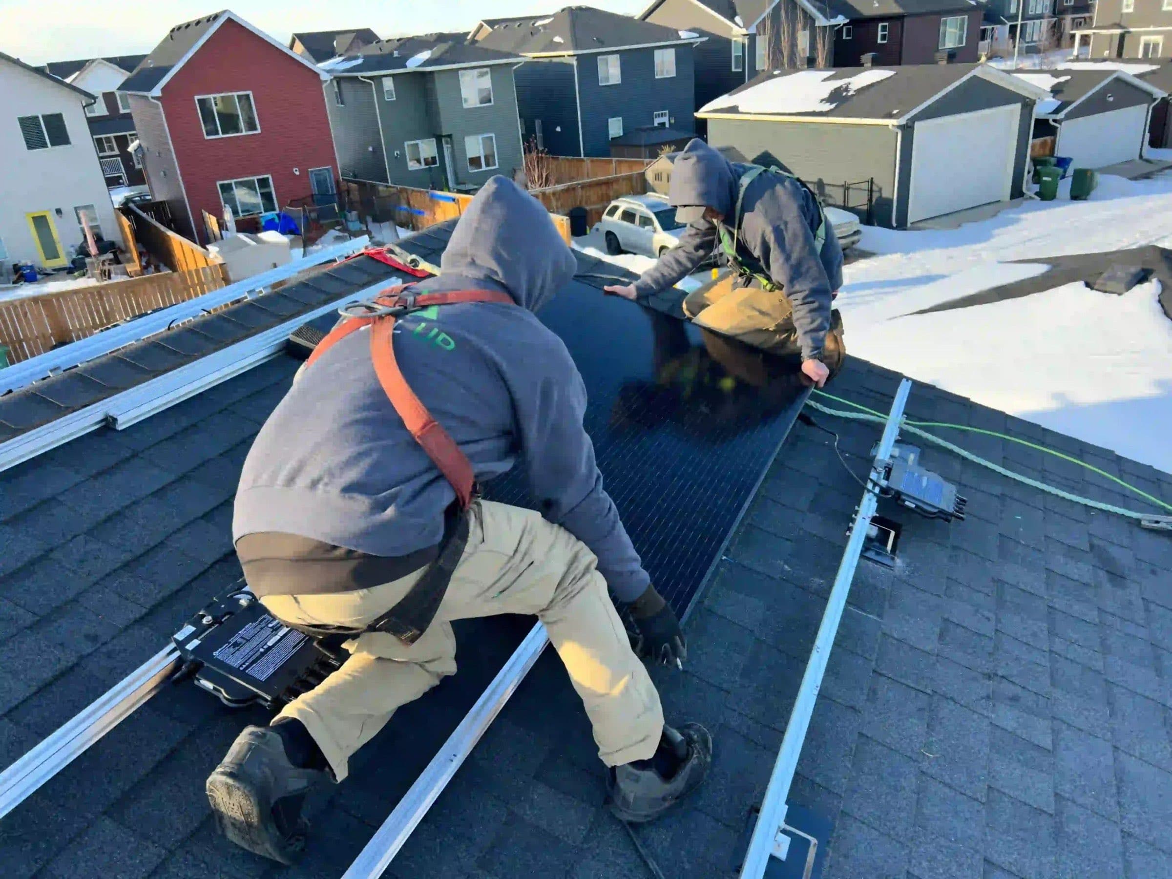 A roofer fitting shingles on a Calgary roof